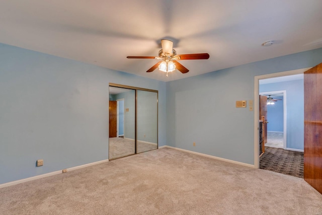 unfurnished bedroom featuring ceiling fan, light colored carpet, and a closet