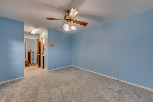 empty room with ceiling fan and light colored carpet