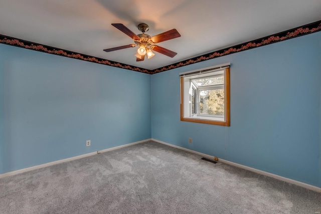 carpeted empty room featuring ceiling fan