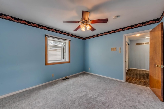 carpeted empty room with ceiling fan