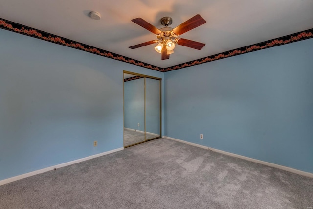 carpeted empty room with ceiling fan