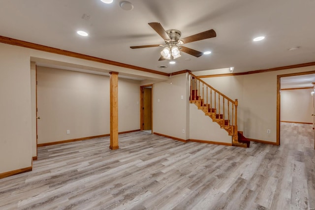 basement featuring light wood-type flooring, ceiling fan, and crown molding