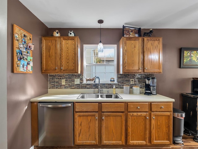 kitchen featuring a sink, brown cabinetry, dishwasher, decorative backsplash, and light countertops