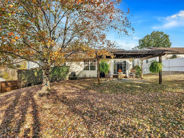 rear view of house with a patio and a fenced backyard