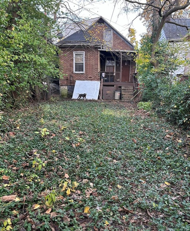 back of property with covered porch