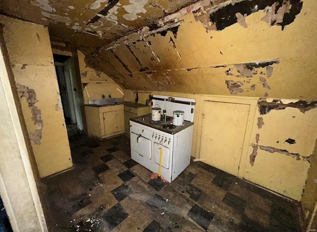 kitchen featuring lofted ceiling and white stove