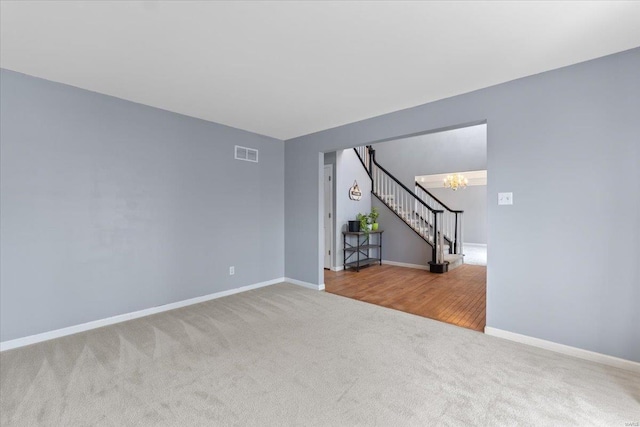 empty room with a chandelier and carpet