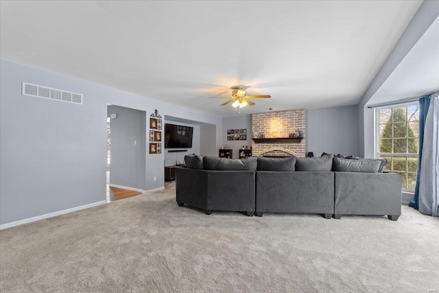 carpeted living room with ceiling fan