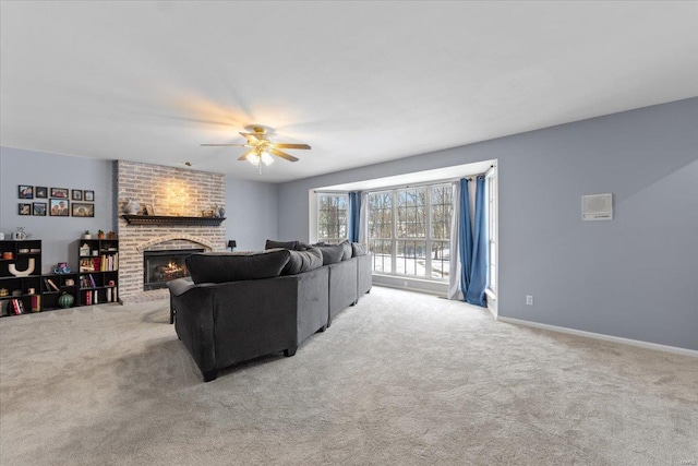 living room featuring a brick fireplace, light colored carpet, and ceiling fan