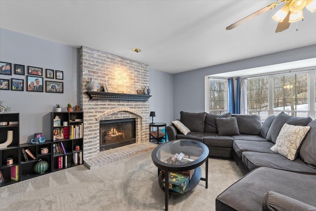 living room featuring ceiling fan, light carpet, and a brick fireplace