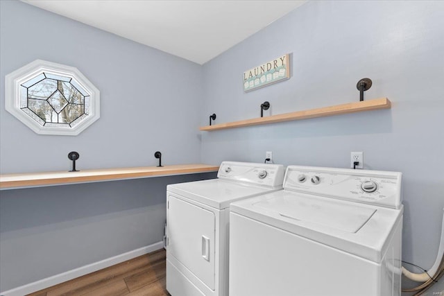 laundry room with hardwood / wood-style floors and washer and clothes dryer