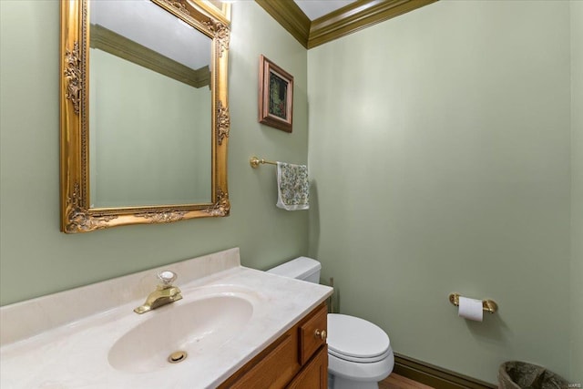 bathroom featuring ornamental molding, vanity, and toilet