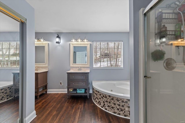 bathroom with hardwood / wood-style flooring, vanity, and shower with separate bathtub