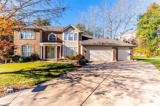 view of front of property featuring a garage and a front yard