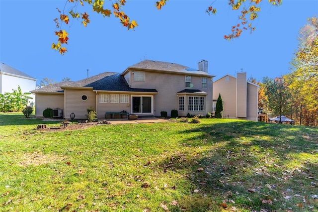 back of house featuring a yard, central AC unit, and a patio