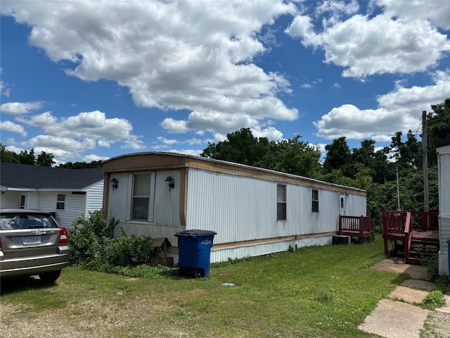 view of front of property featuring a front yard and a deck