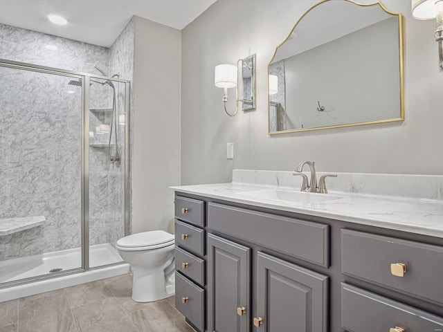 bathroom featuring vanity, an enclosed shower, and toilet