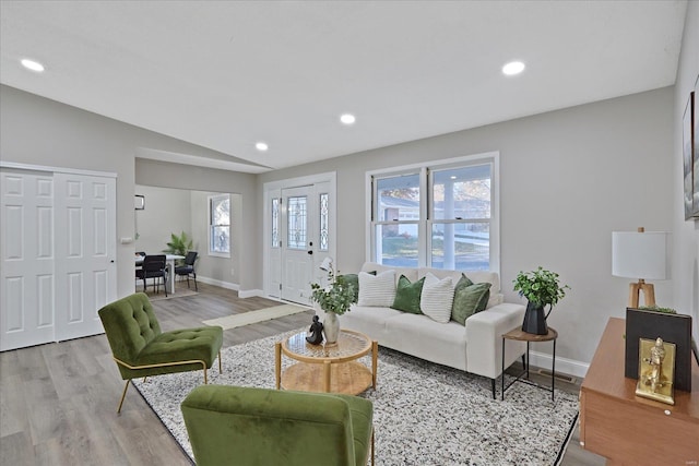 living room featuring light hardwood / wood-style floors and lofted ceiling