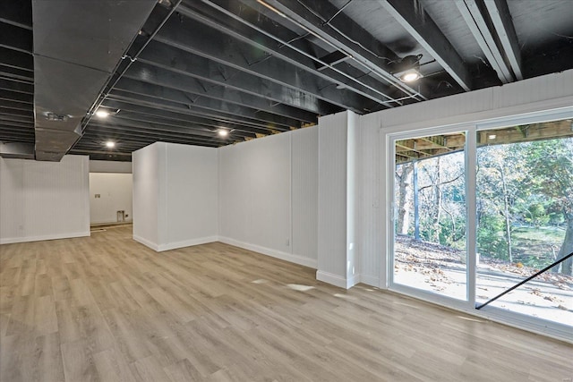 basement with hardwood / wood-style flooring