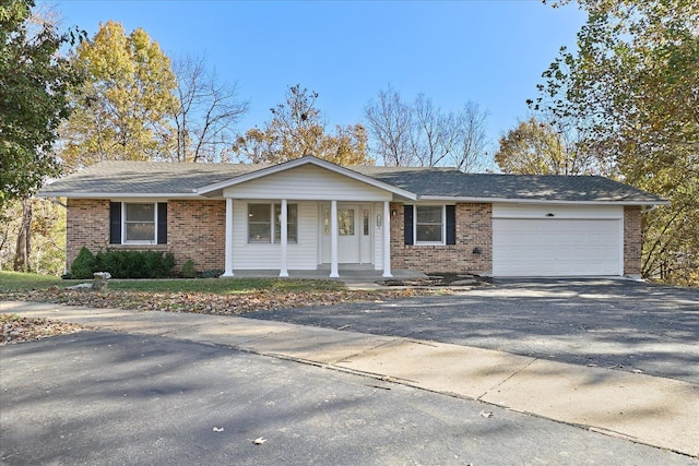 single story home featuring a garage and covered porch