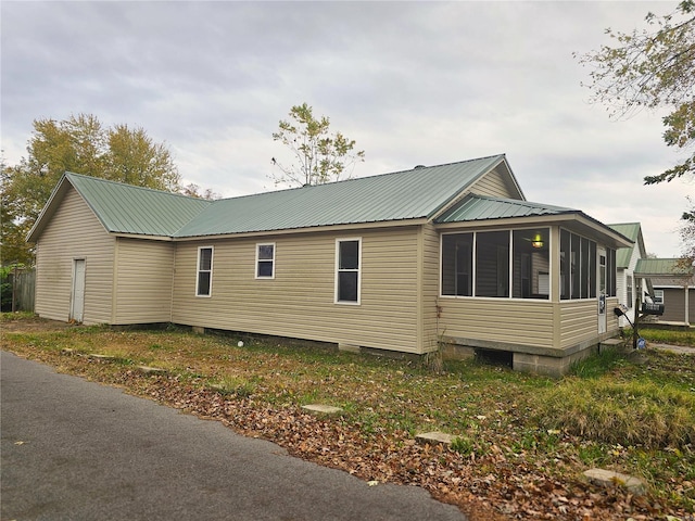 view of side of property featuring a sunroom