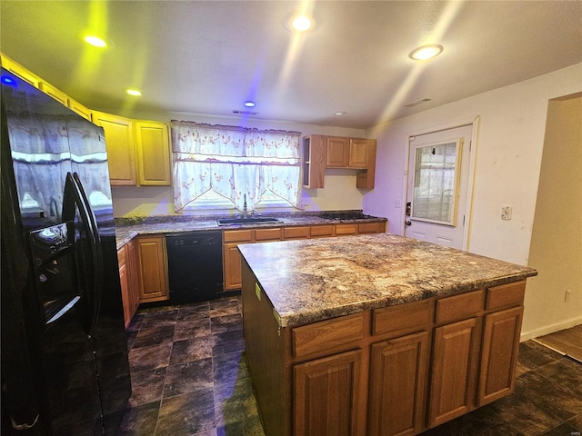 kitchen with sink, black appliances, and a kitchen island