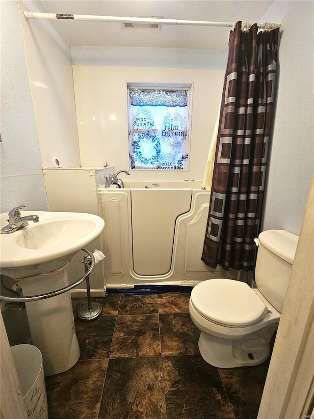 bathroom featuring toilet