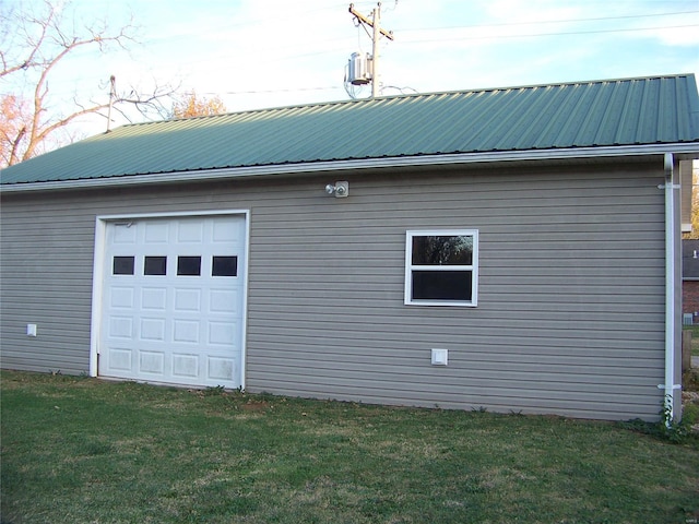 view of home's exterior with a garage, an outdoor structure, and a yard