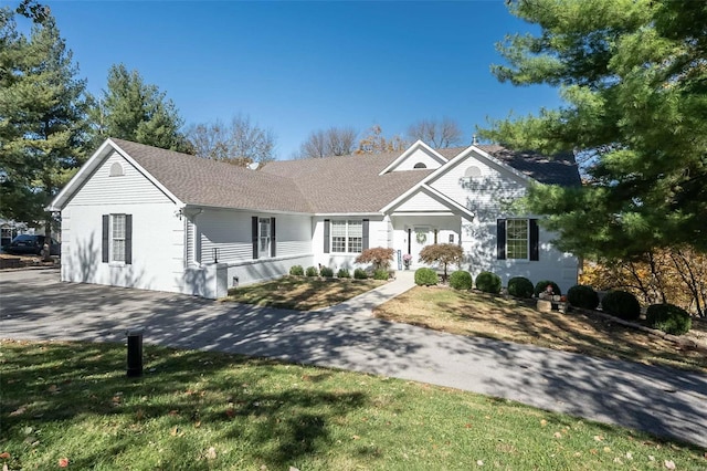 ranch-style home with a front lawn