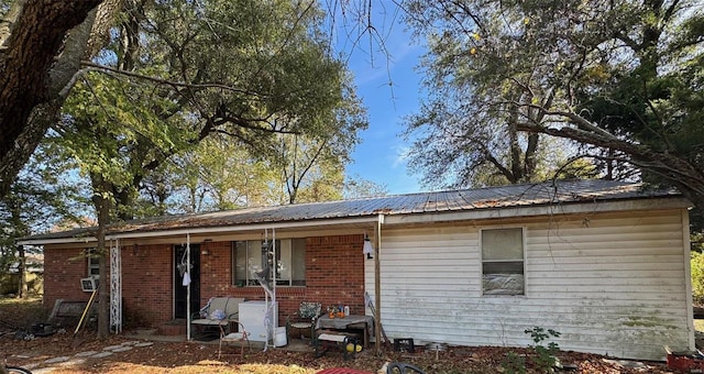 rear view of property with covered porch