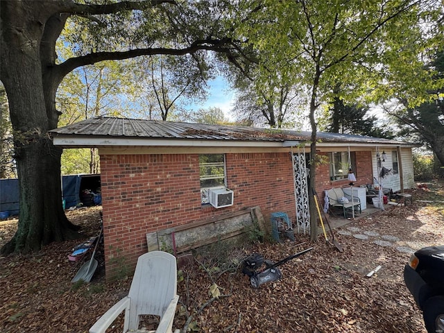 view of side of home with a patio and cooling unit