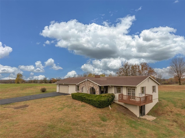 ranch-style house featuring a garage and a front lawn