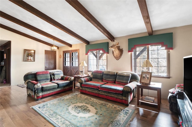 living room featuring lofted ceiling with beams, hardwood / wood-style flooring, and plenty of natural light