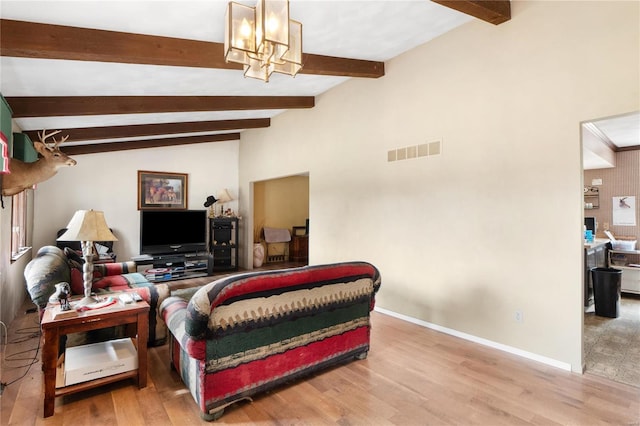 living room featuring a notable chandelier, hardwood / wood-style flooring, and lofted ceiling with beams