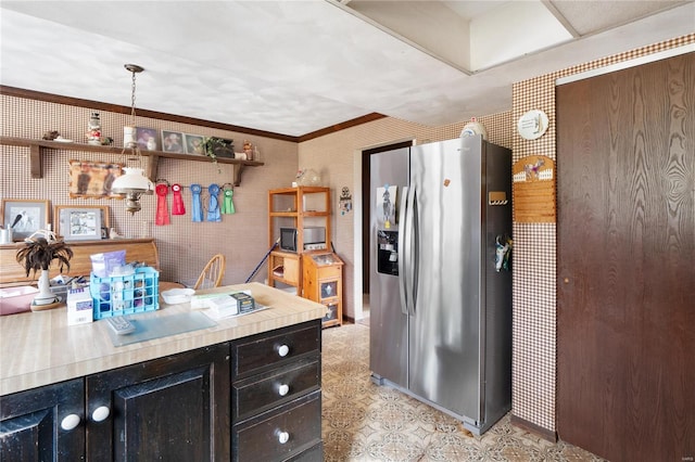 kitchen featuring crown molding, pendant lighting, and stainless steel fridge with ice dispenser