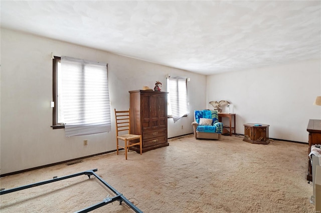 sitting room featuring a healthy amount of sunlight and carpet floors