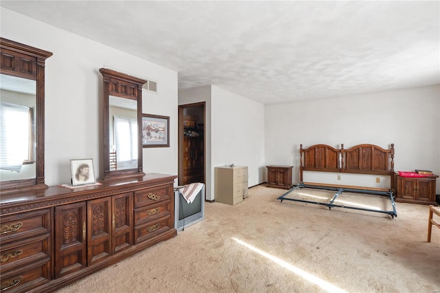 bedroom featuring multiple windows and light colored carpet