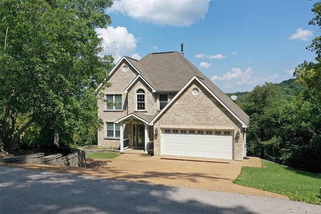 view of front of home featuring a front lawn and a garage