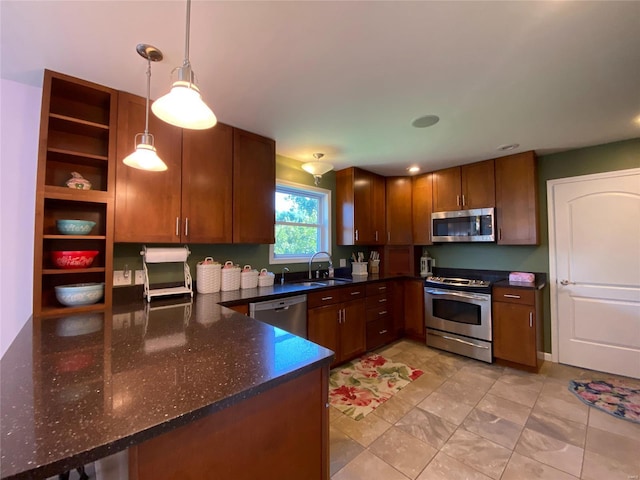 kitchen with sink, pendant lighting, kitchen peninsula, and stainless steel appliances