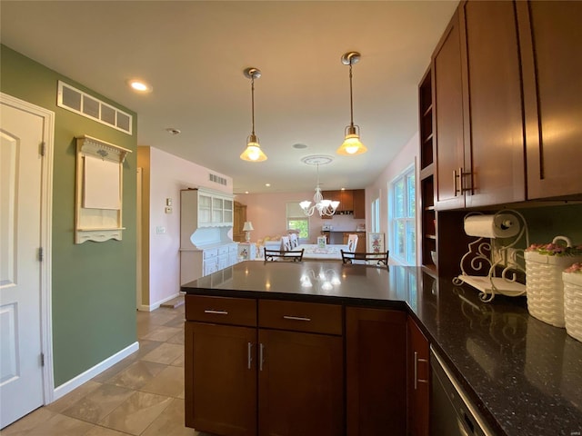 kitchen with hanging light fixtures, light tile patterned floors, an inviting chandelier, stainless steel dishwasher, and dark stone counters