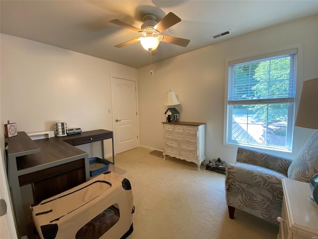 interior space featuring light colored carpet and ceiling fan