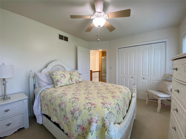 carpeted bedroom featuring a closet and ceiling fan