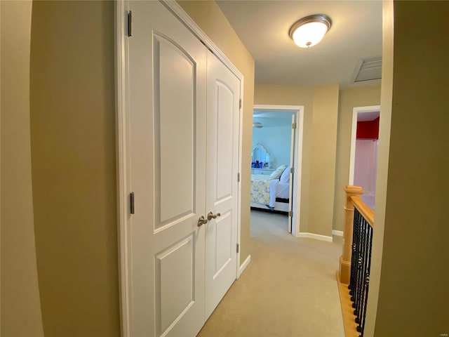 hallway featuring light carpet