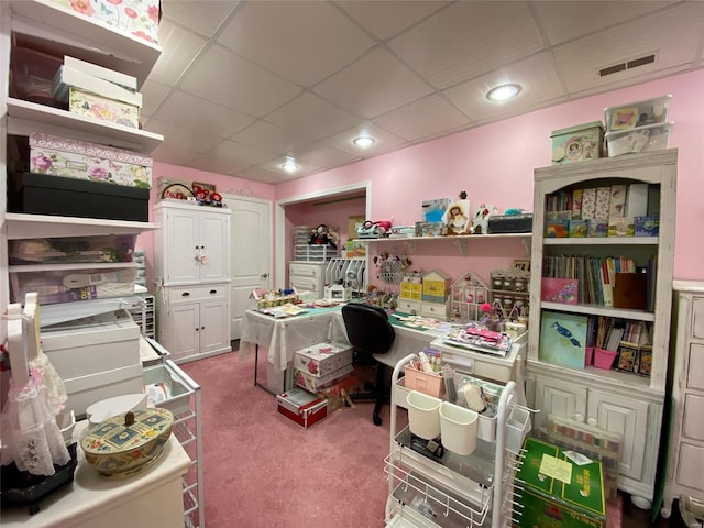 carpeted home office with a drop ceiling