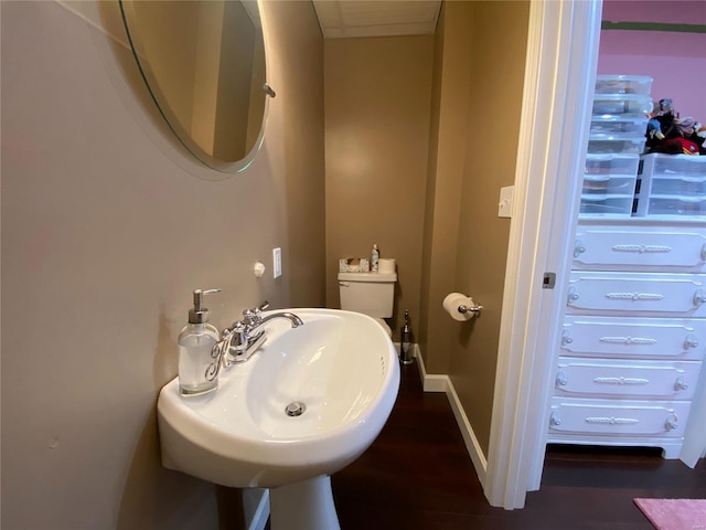 bathroom with sink, hardwood / wood-style flooring, and toilet