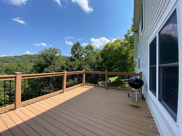 wooden terrace with a grill