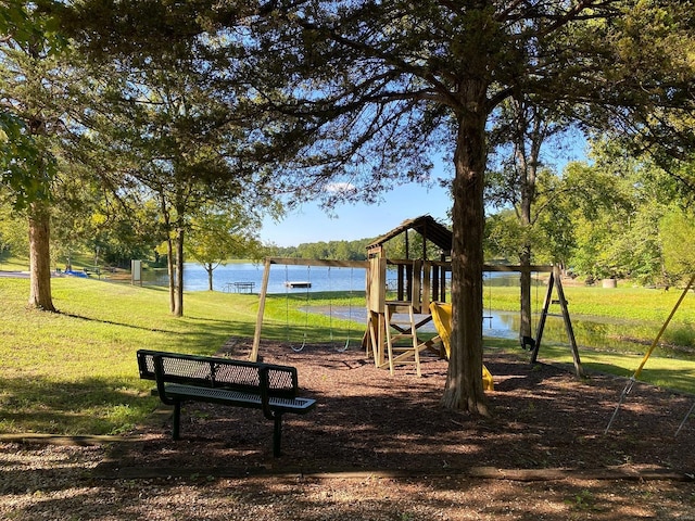 view of play area featuring a yard and a water view