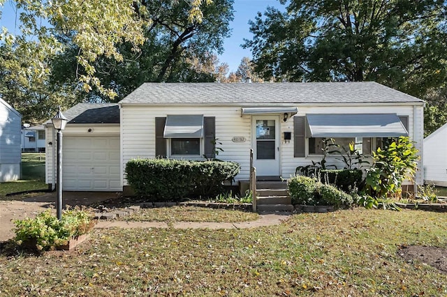 view of front of house with a front lawn and a garage