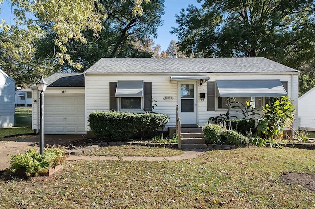 bungalow featuring an attached garage, driveway, and roof with shingles