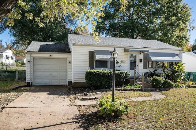 bungalow featuring a garage, roof with shingles, fence, and driveway
